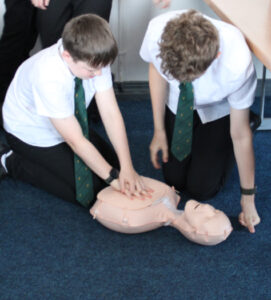 Students performing CPR on dummies.