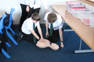 Photo of students on futures day learning CPR.