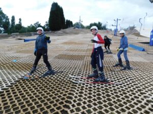 Photo of students skiing down a dry ski slope during the ski trip.