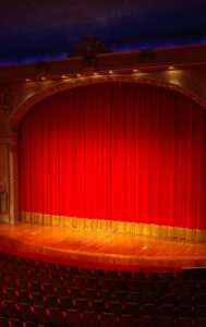 Photo of the stage inside  of a theatre.