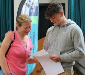 Photo of Sixth Form Helsby student and parent opening Level 3 results